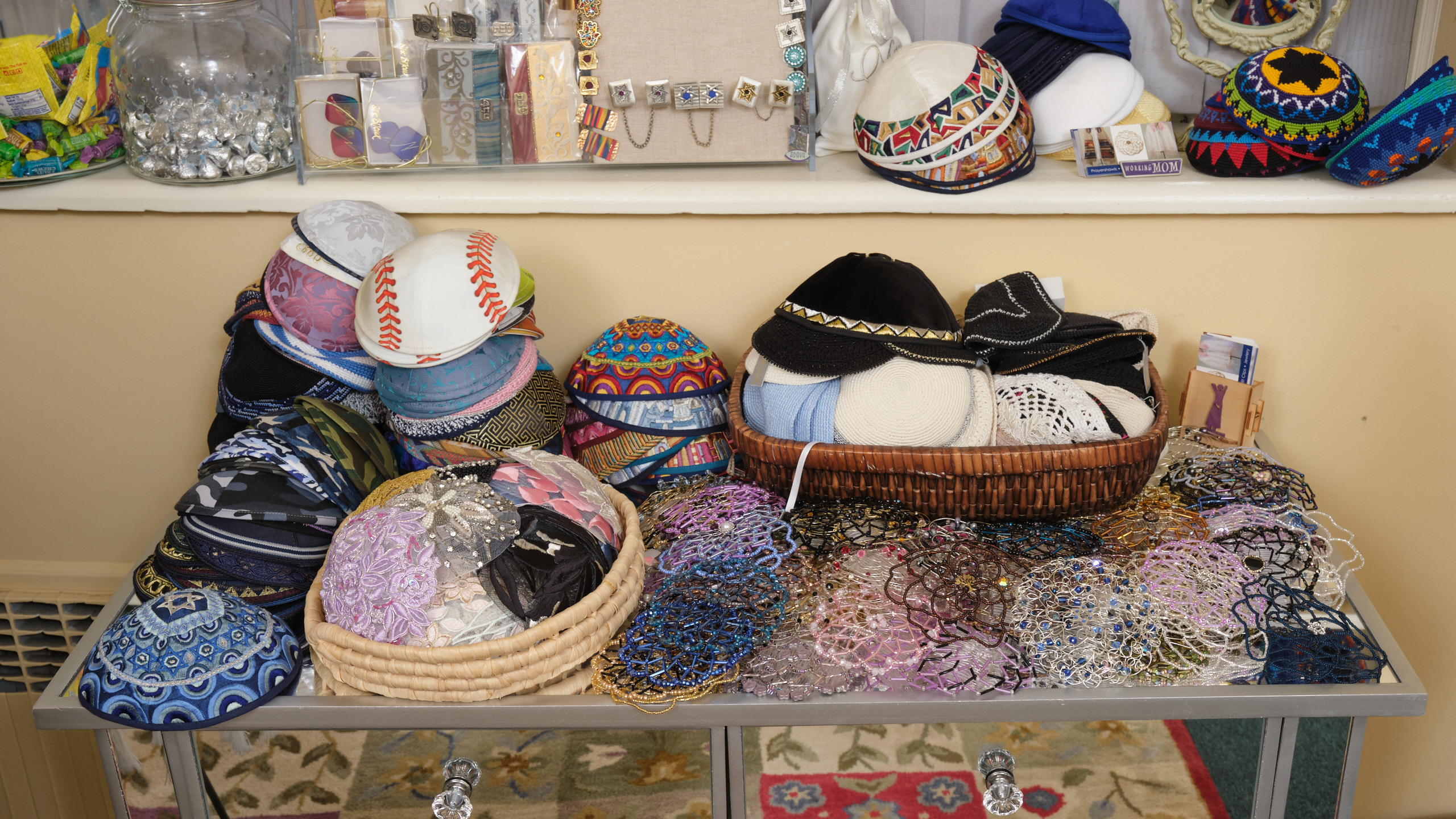 Table full of personalized kippah.